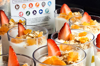 A photo of several rows of yoghurt, fruit and granola cups.
