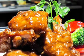A plate of chicken wings with vegetables.