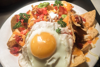 A plate of breakfast chilaquiles mexicanos.